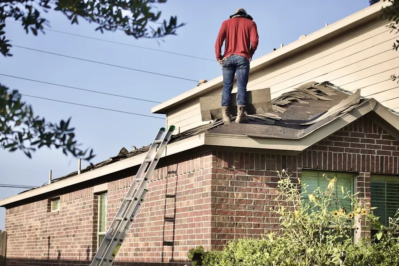 Professional roofer working on a residential roof in Prallsville